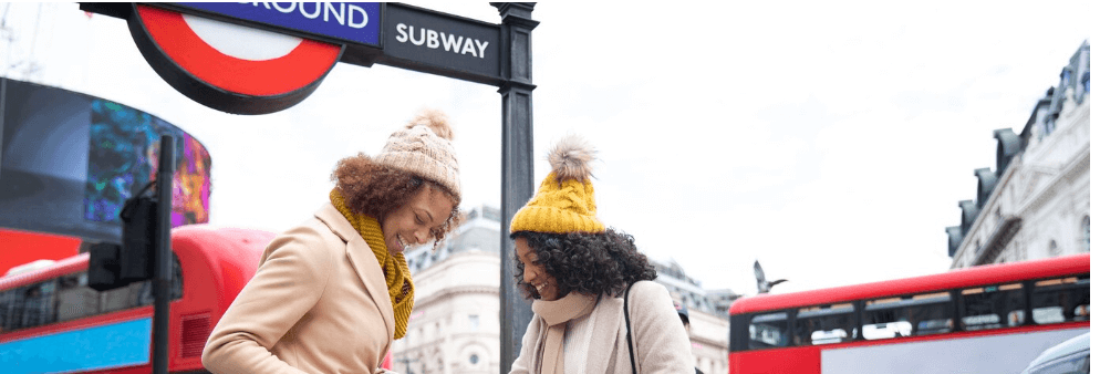 women in front of sign