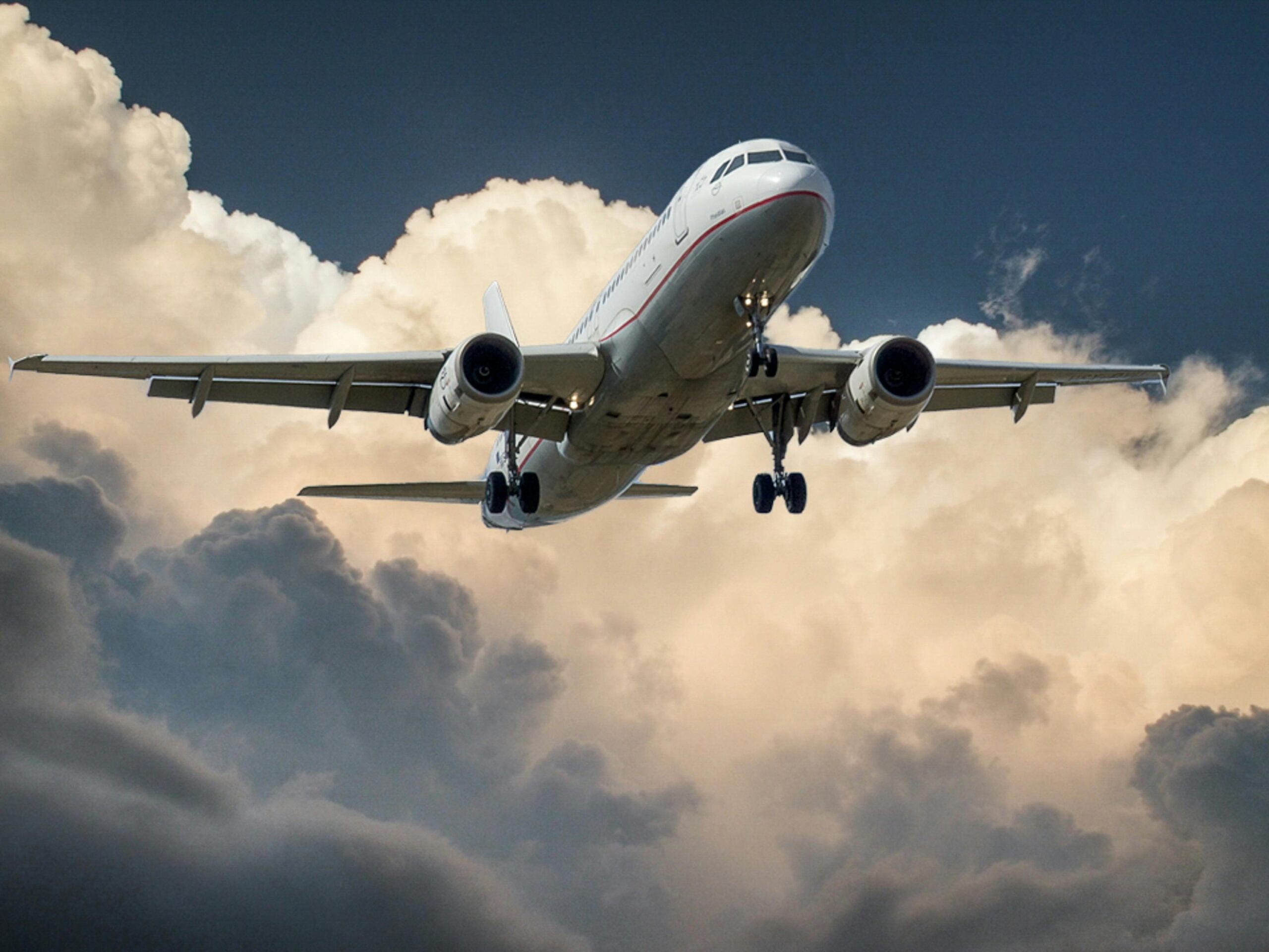 aircraft-jet-landing-cloud-46148-46148 A commercial airplane flying through dramatic clouds, showcasing aviation in action.