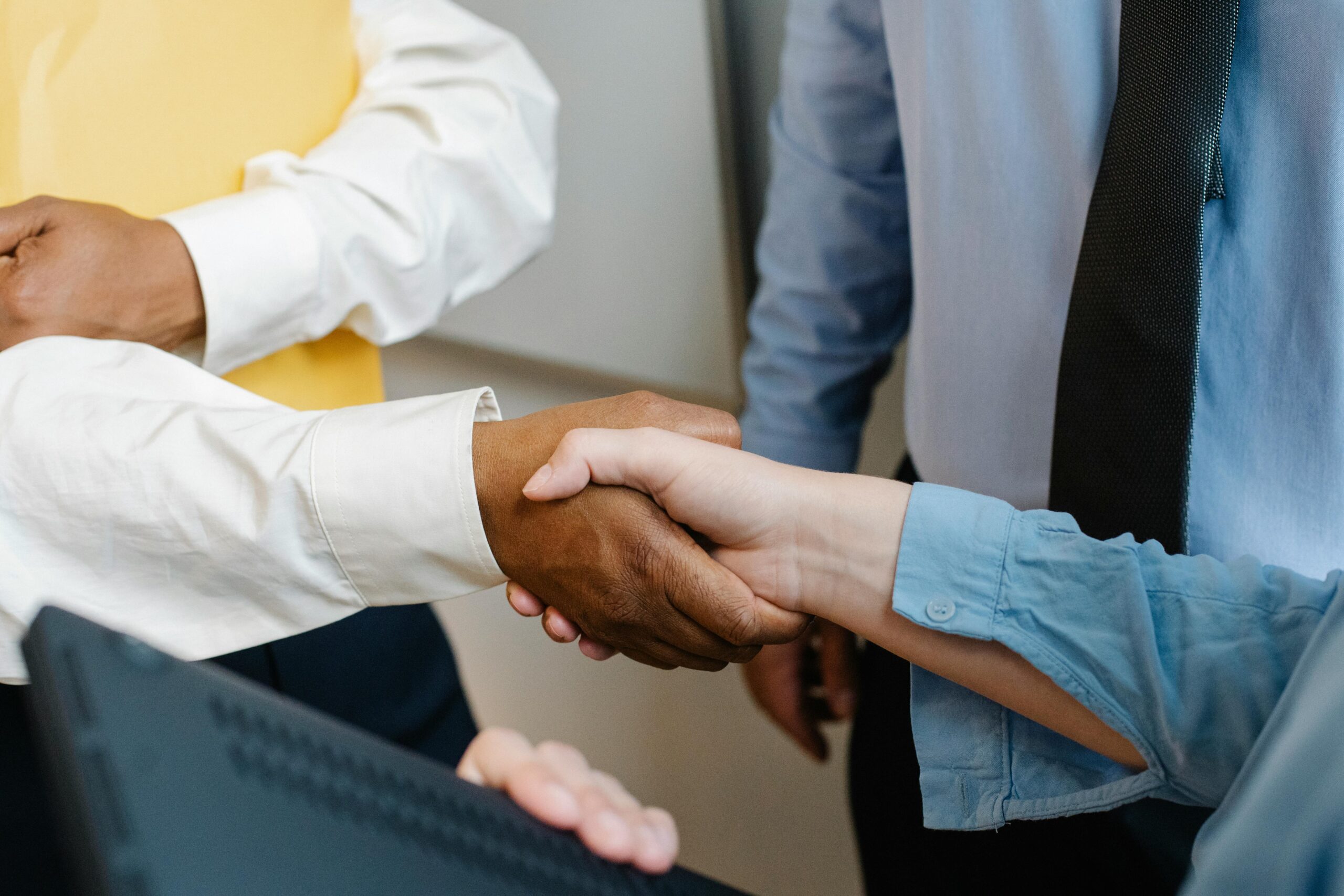 pexels-photo-5668838-5668838 Crop anonymous diverse entrepreneurs shaking hands after meeting and negotiating about new project