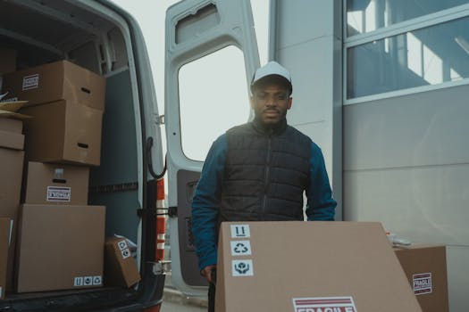 pexels-photo-6169663-6169663 A delivery man unloads boxes from a van, showcasing logistics in action.