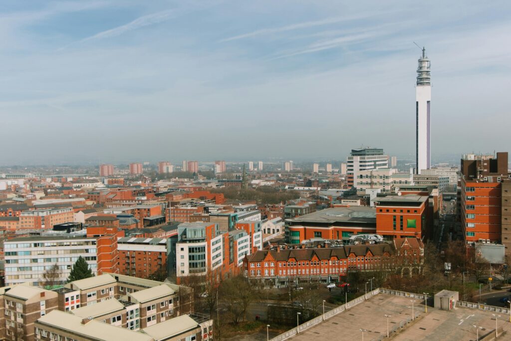 Panoramic view of Birmingham, UK showcasing the BT Tower and urban skyline.