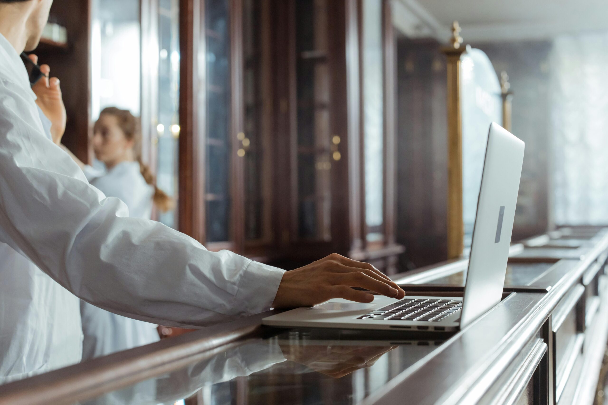 Scientist using a laptop in a laboratory, highlighting research and technology integration.