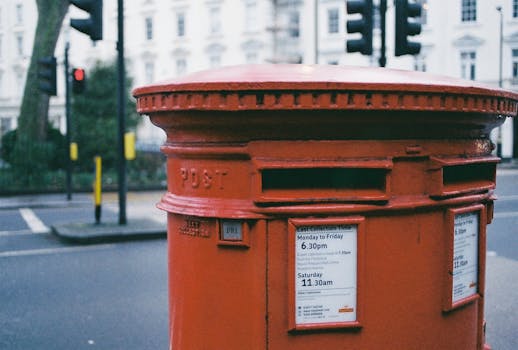 pexels-photo-947384-947384-1 A traditional red post box on a London street corner, capturing the essence of city life.